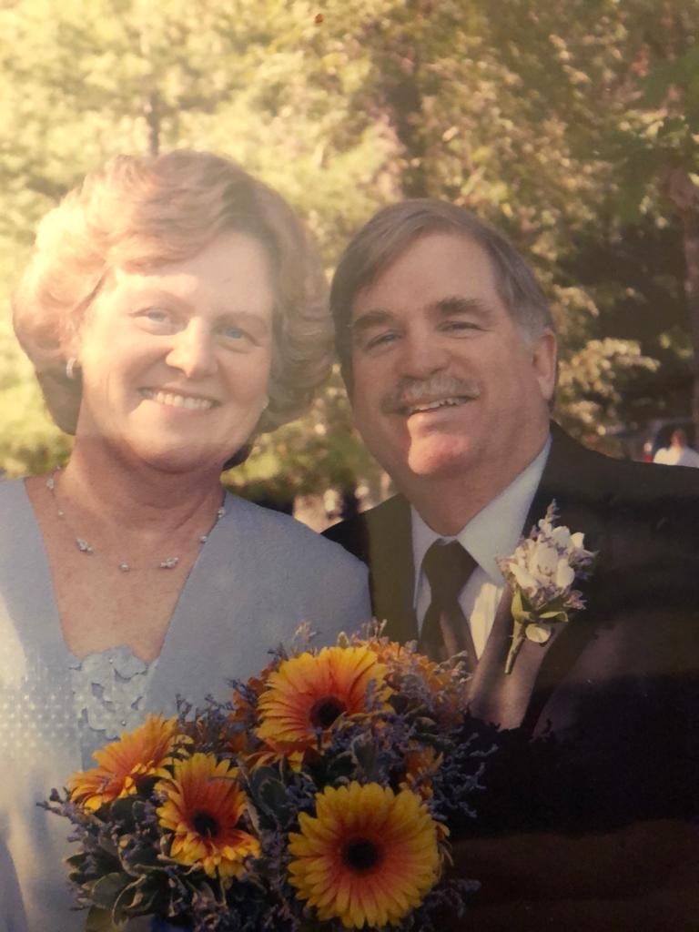 Couple holding a sunflower bouquet