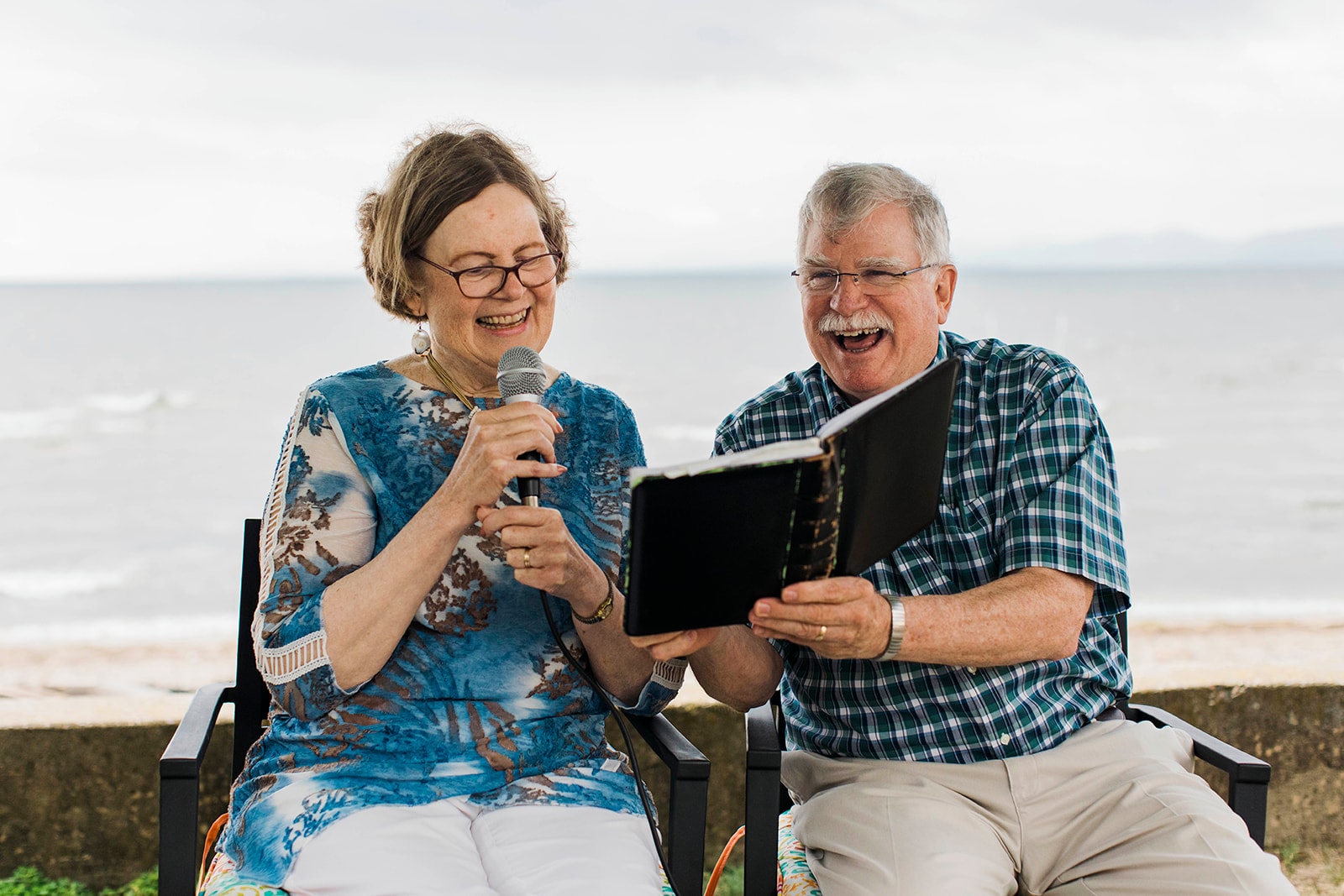 Couple reading the Bible by the ocean shore